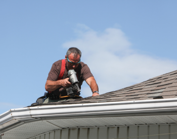 Thomas Roofing team repairing roof damage