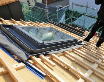 Thomas Roofing team installing a skyligh